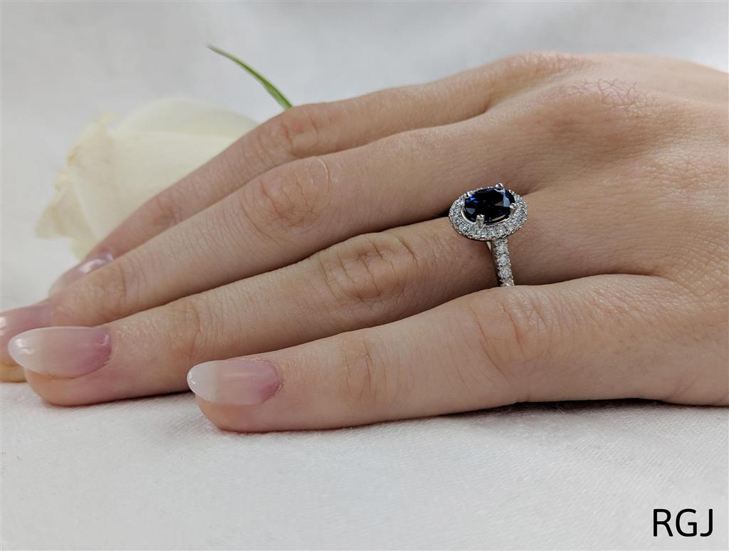 The Skye Platinum 1.43ct Oval Cut Blue Sapphire Ring With 0.41ct Diamond Halo And Diamond Set Shoulders