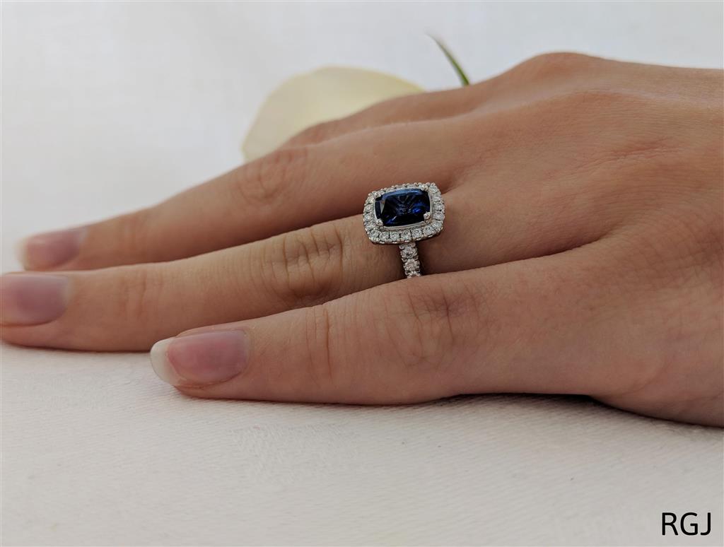 The Skye Platinum 1.81ct Cushion Cut Blue Sapphire Ring With 0.43ct Diamond Halo And Diamond Set Shoulders